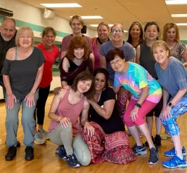 Group of YMCA members posing in a group exercise studio at the Kennett Area YMCA.