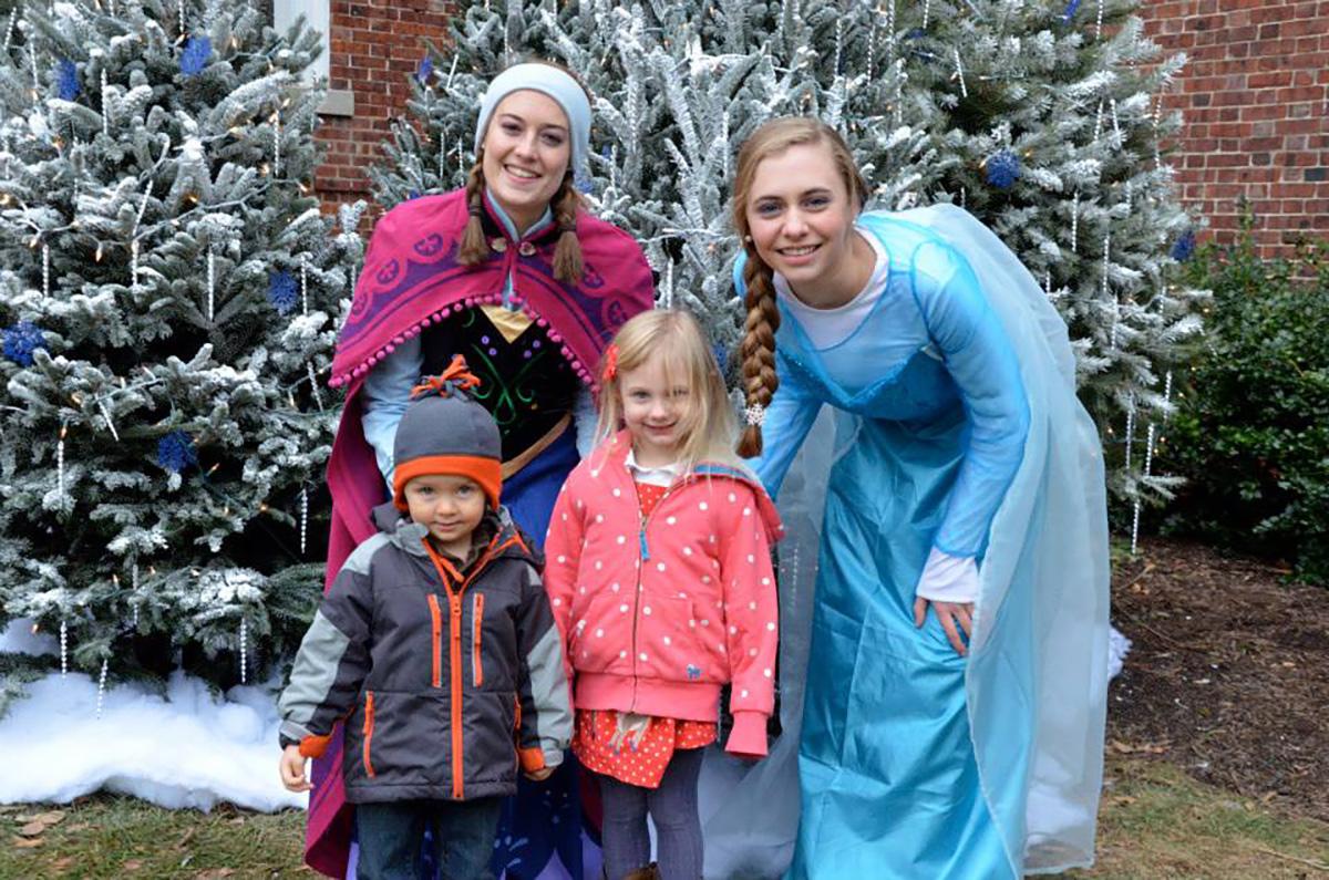 Elsa and Anna pose with kids at the Upper Main Line YMCA Christmas Festival