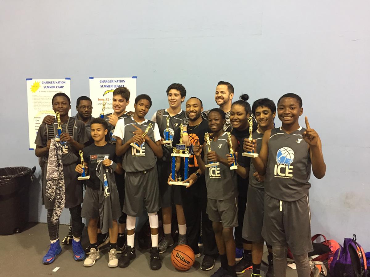 YMCA AAU Youth Basketball Team celebrates a tournament win.