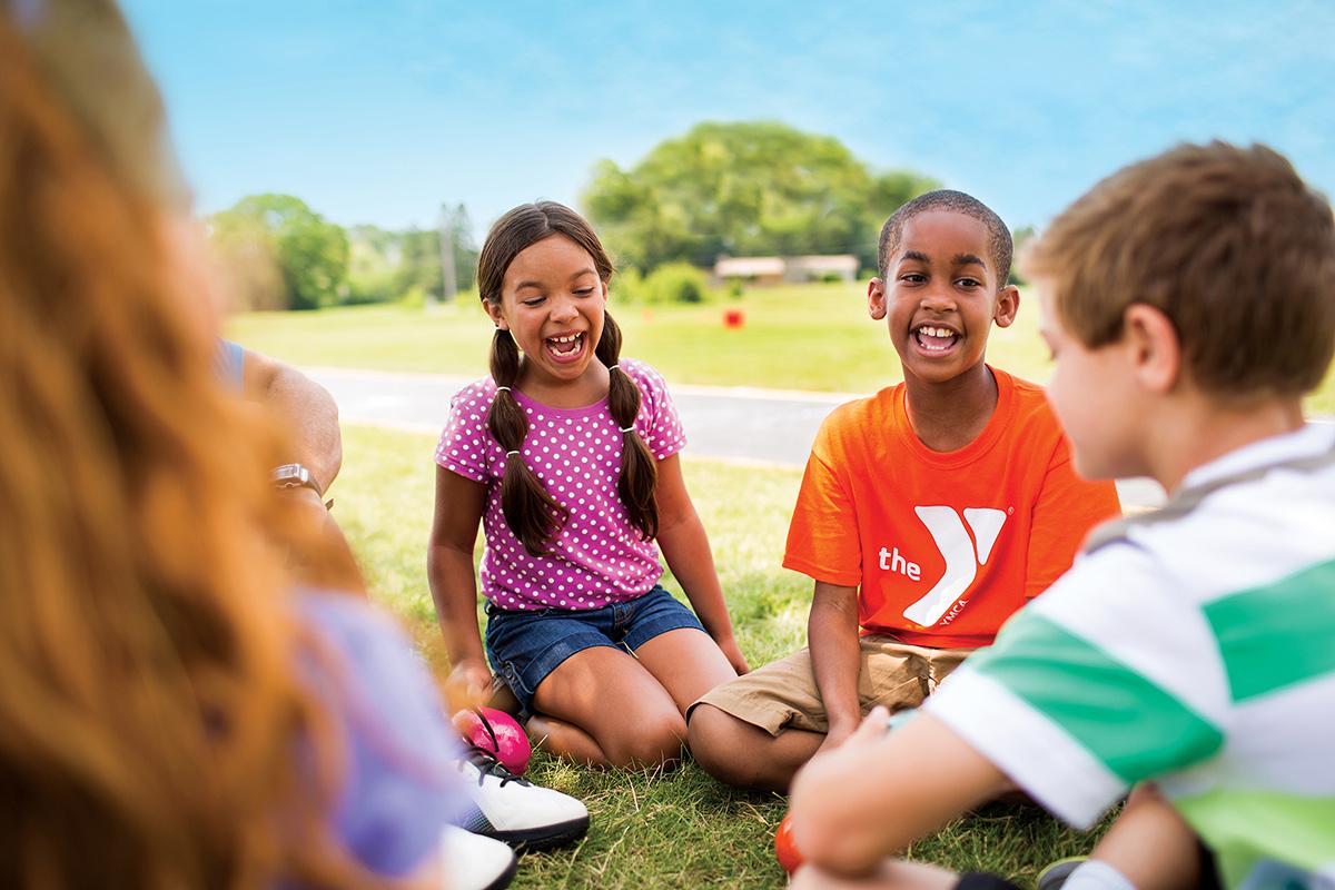 Kids playing outside during summer camp at the YMCA