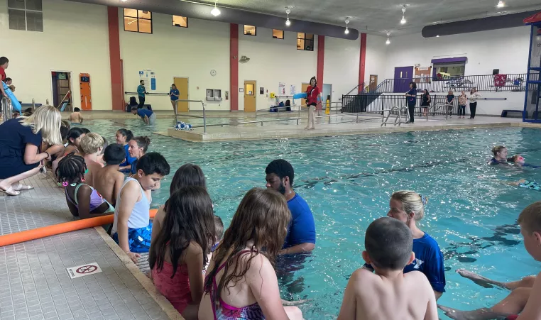 Instructors lead students in water safety programs at the pool 