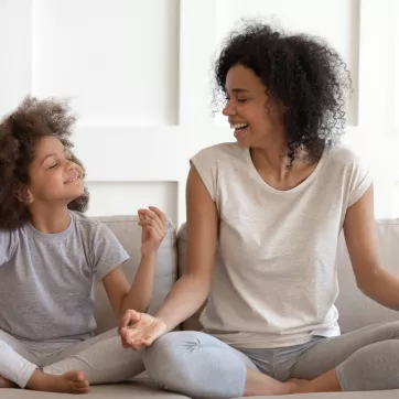 Child attempts to meditate with parent