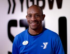 Kennett Personal trainer Kareem Lanier poses for a headshot in the Kennett Area YMCA gym.