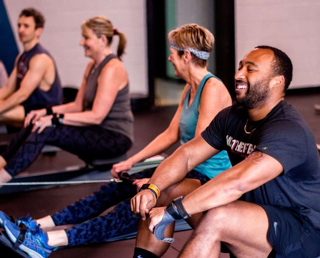 Members of East Chestnut Fitness using rowing machines while participating in the EVOLT 360 Fitness Challenge at the YMCA of Greater Brandywine.