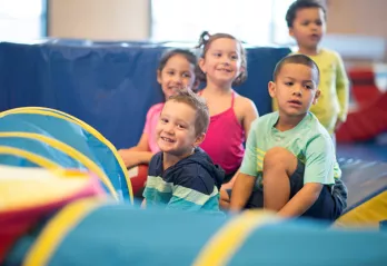 A group of children participate in a tumbling class at the YMCA Gymnastics Center in West Chester