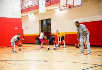 Preschool and elementary school students participate in a YMCA basketball and all sports clinic in the gym at the Oscar Lasko YMCA in West Chester, PA.