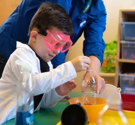 A young boy participates in a science project during a STEM class in the science lab at the Upper Main Line YMCA in Berwyn, PA