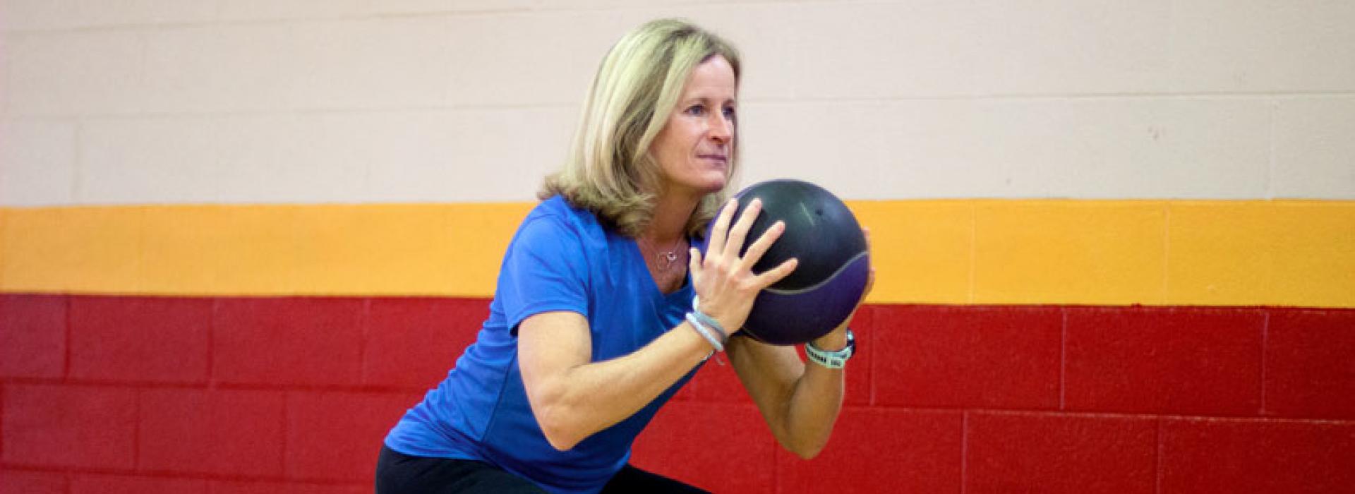 West Chester Area YMCA Personal Trainer Cari Wolfe Demonstrates a workout with using a disc and weighted ball in the gym at the west chester location. 