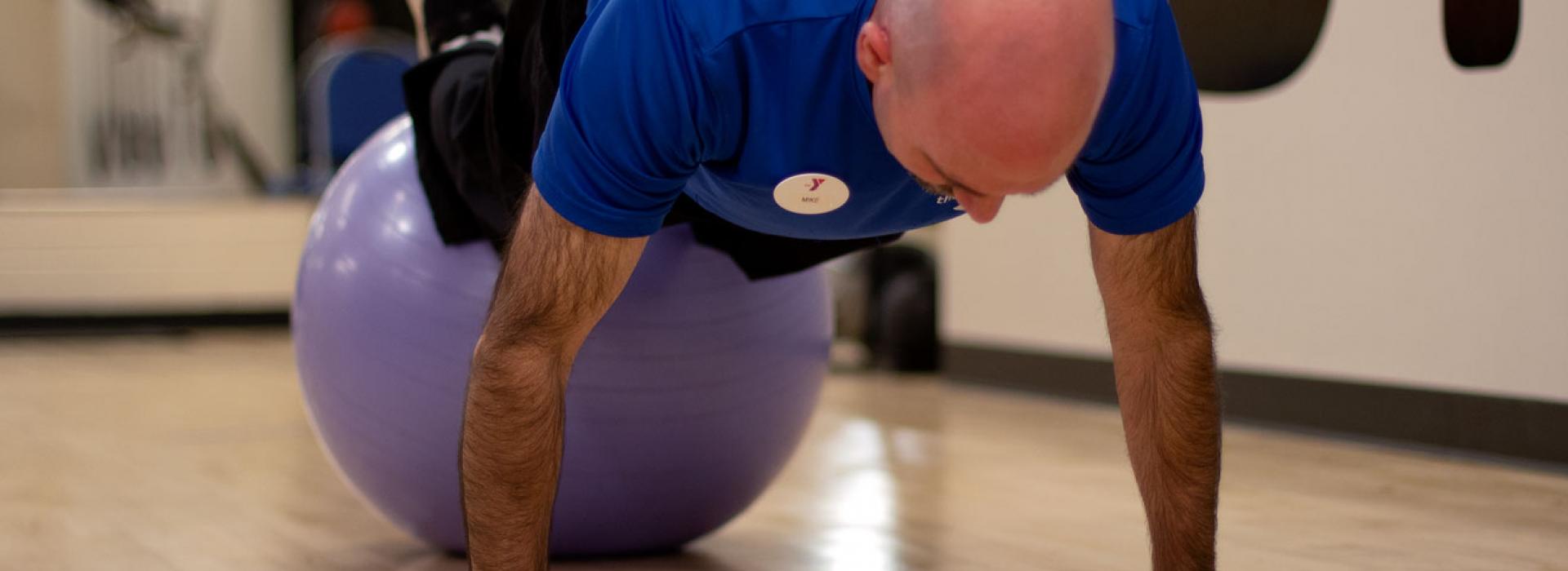 Mike LoBiondo, a personal trainer at the Kennett Area YMCA, demonstrates exercises using a balance ball.