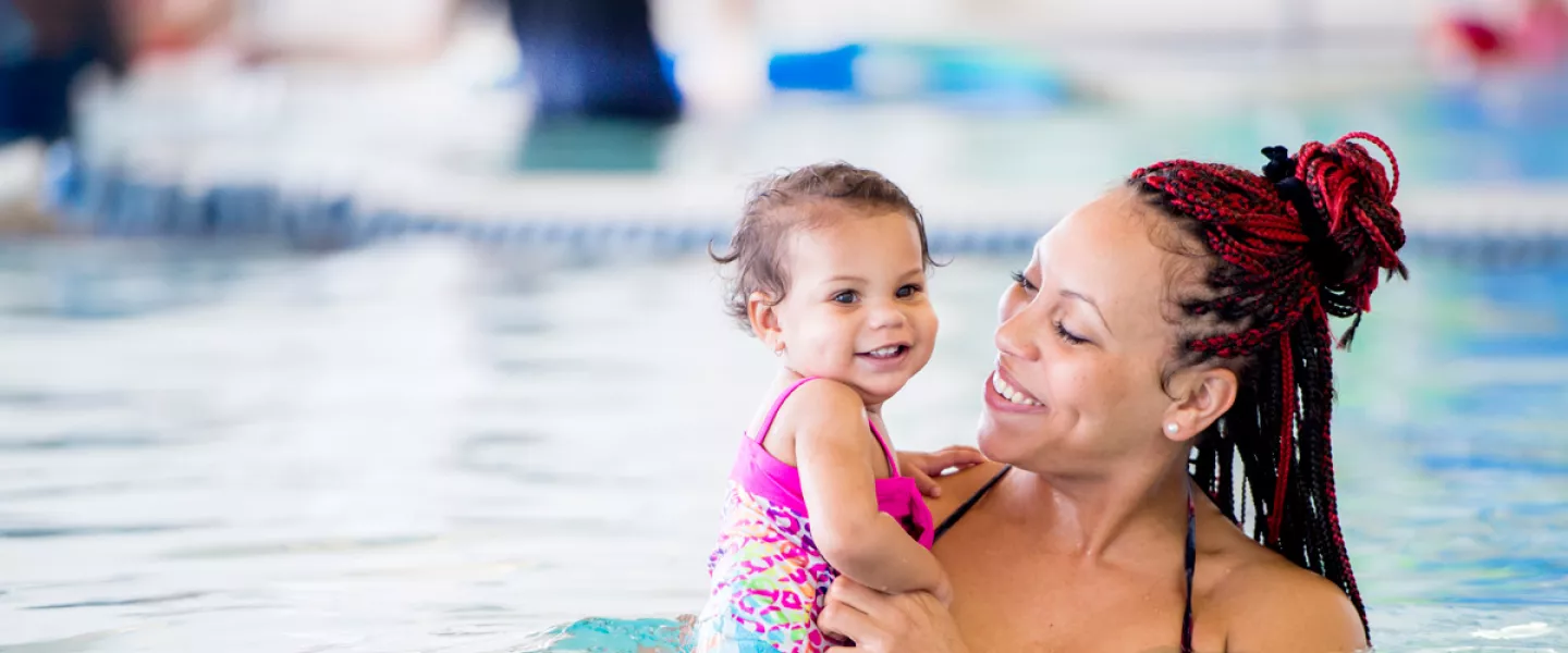 A mother and daughter participate in swimming lessons for toddlers at the indoor swimming pool in the YMCA in Chester County