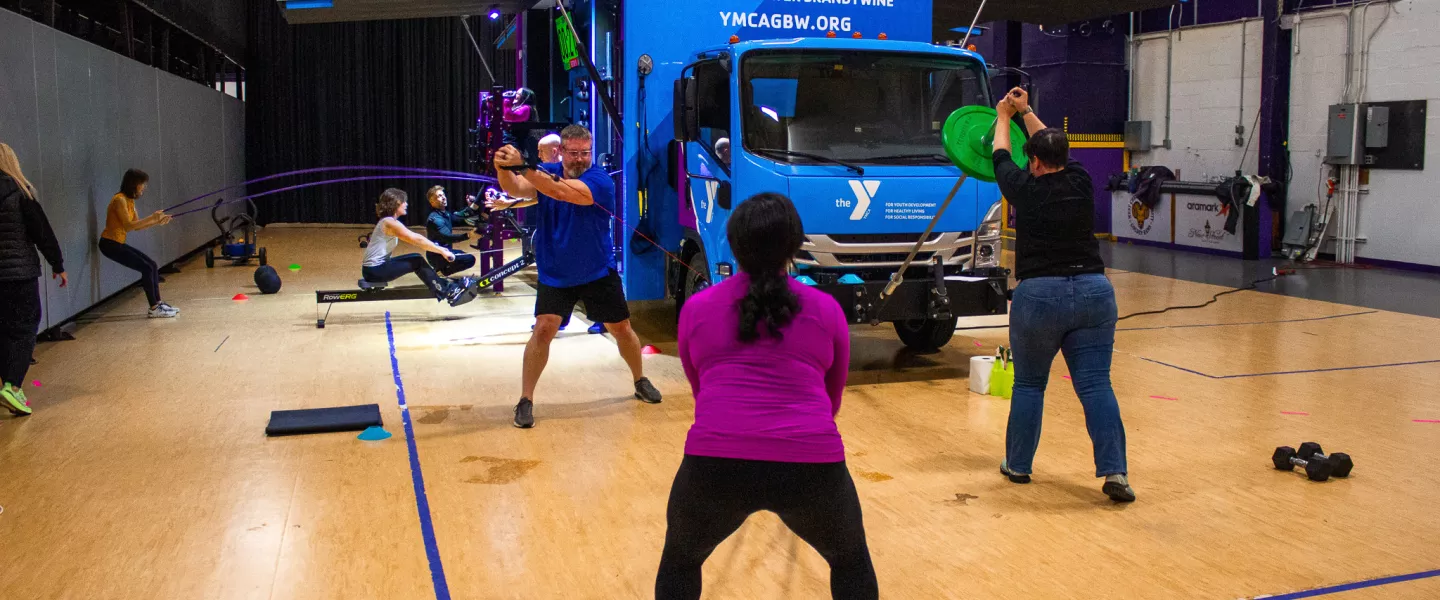 A group of wellness directors learning how to use the YMCA of Greater Brandywine mobile fitness truck, YGBW Fit Truk.