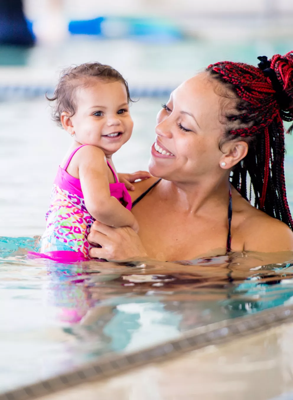 A mother and daughter participate in swimming lessons for toddlers at the indoor swimming pool in the YMCA in Chester County