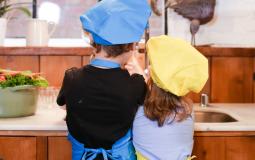 A boy and a girl participate in a cooking activity during a Budding Chef class at the YMCA
