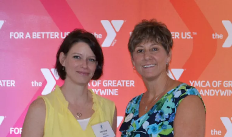 YMCA CEO Denise Day poses with a 2016 volunteer award recipient during the 2016 ceremony