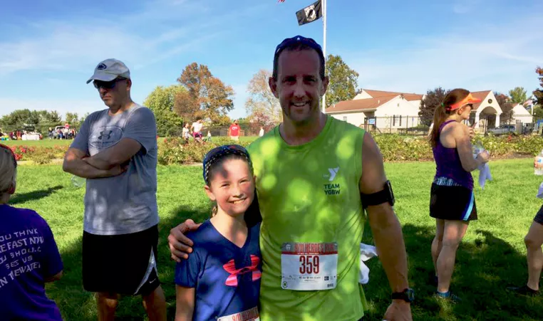 Dad and daughter posing after participating in the J5k, a 5K race in West Grove PA