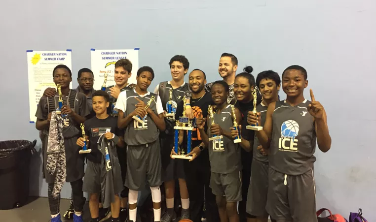 YMCA AAU Youth Basketball Team celebrates a tournament win.