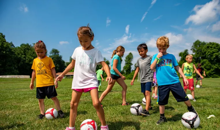 A group of kids practice their soccer skills at soccer summer camp at the Brandywine YMCA in Coatesville, PA. 