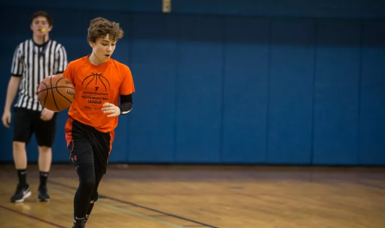 Teen playing basketball at the YMCA of Greater Brandywine
