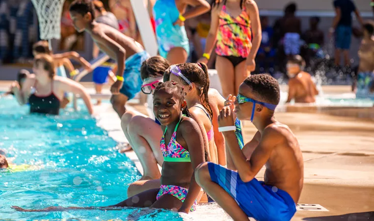 Kids cool off at the Brandywine YMCA outdoor pool at summer camp. 