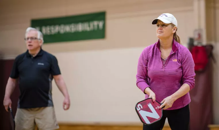 YMCA members prepare to a receive a serve playing pickleball at the indoor gym at the west chester area ymca in west chester, pa.