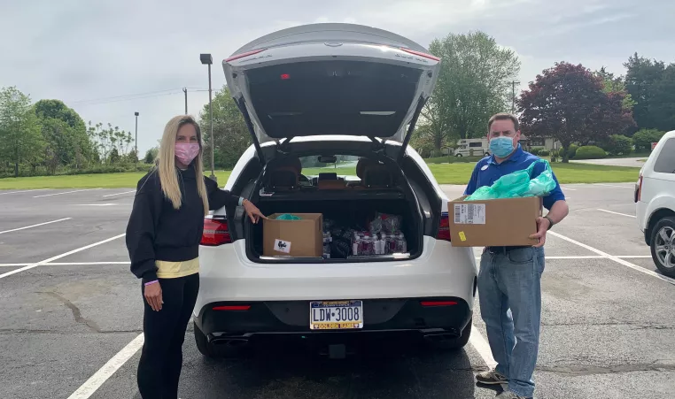 Kristin Proto, Executive Director of the Garage Youth Center and Aaron Karpas of the YMCA of Greater Brandywine donate HotSpots to families in need.