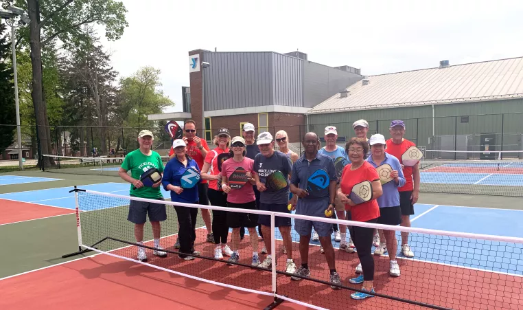 Group of YMCA Pickleball Club players pose after a pickleball event at the Upper Main Line YMCA in Berwyn PA