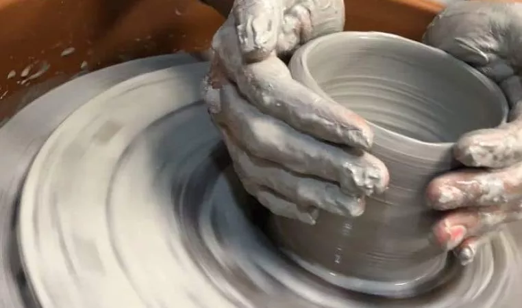 Hands using a pottery wheel 