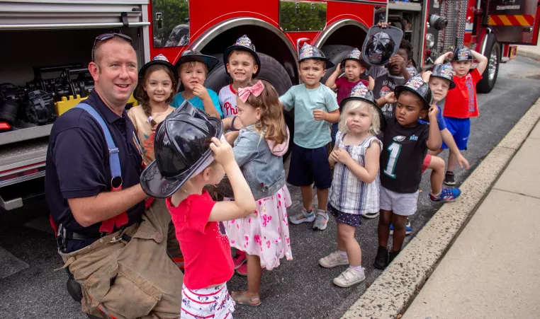 YMCA Students pose for a photo with Goshen Fire Company Firefighter Dave Meadows