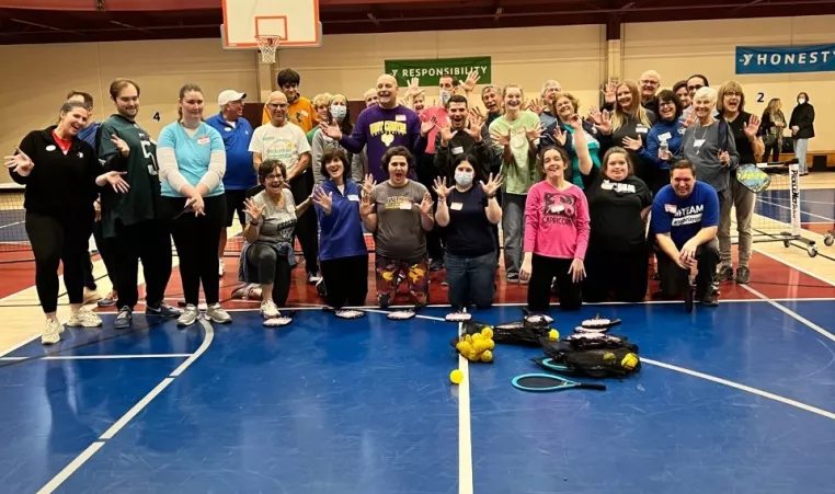 A group of participants and volunteers celebrate at the West Chester Area YMCA during the kick-off of the YMCA's Adaptive Pickleball program in January of 2023. Adaptive Pickleball is adapted to meet the needs of adults with developmental delays and disabilities and is offered monthly at the YMCA Pickleball Center at Downingtown.