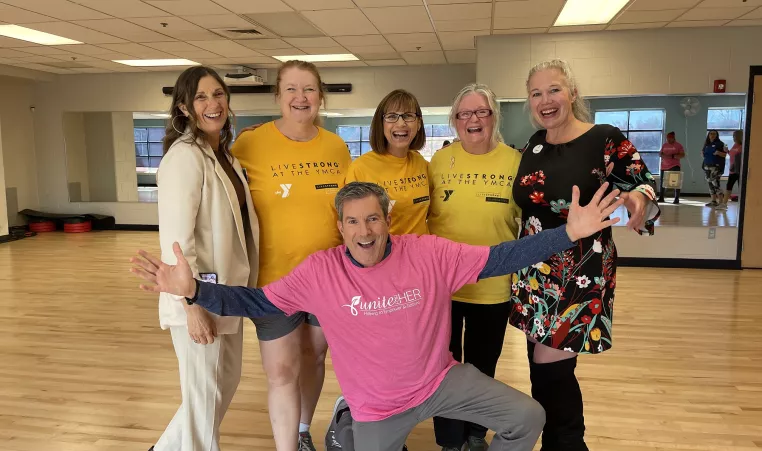 Bob Kelly, FOX29 Anchor, poses with cancer patients who participate in Unite for HER and LIVESTRONG at the YMCA.