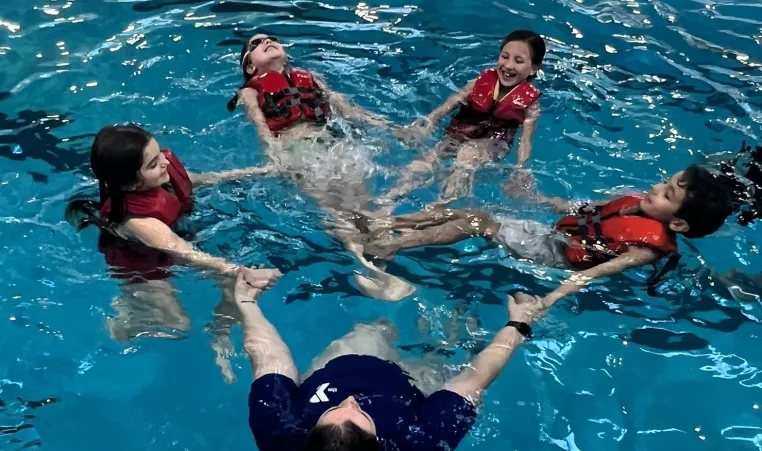Children in Life Vests Learn Water Safety at the Y