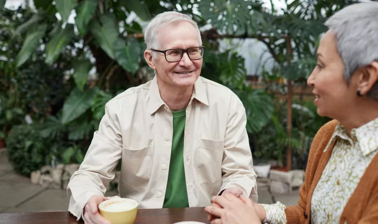 Two Senior Adults Having Coffee and Conversation