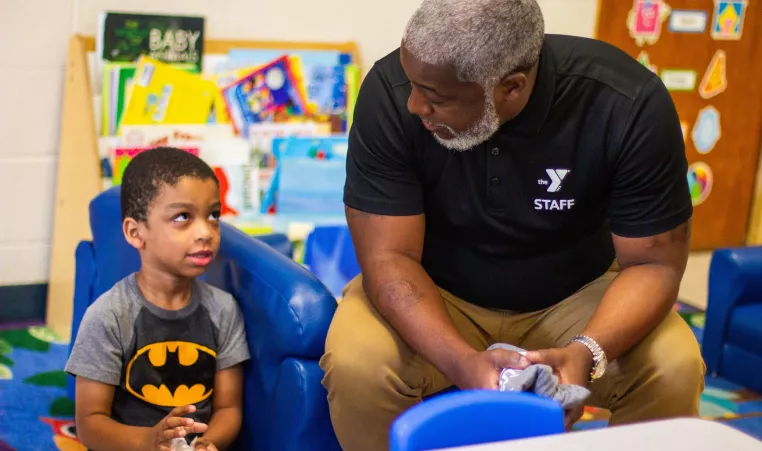 YMCA staff member engages with student in Early Learning Center 