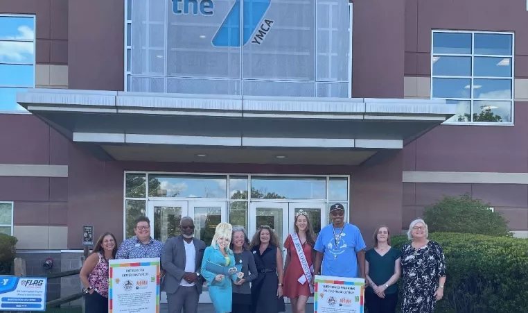 Leaders from the YGBW, AHHAH and the Justamere Foundation pose for a photo with a cardboard cutout of Dolly Parton outside the West Chester Area YMCA. From left to right: Mary Curcio, Bridgette Barbera-Byrne, Bertram L. Lawson II, Dolly Parton, Jan Michener, Claudia Aust, Alyssa Brown, Keith Cochran, Dana Looker and Lori Cushman. 