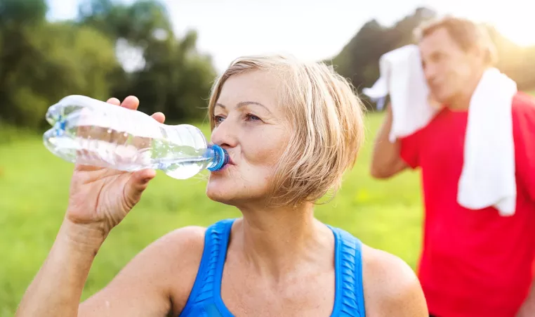 Woman Drinks Water After Exercising