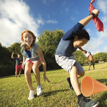 A boy and girl play outside during camp at the YMCA. 