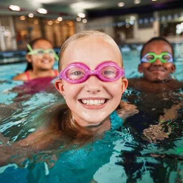 A child enjoys the indoor swimming pool at the YMCA in Chester County while learning to swim at YMCA Swimming lessons.