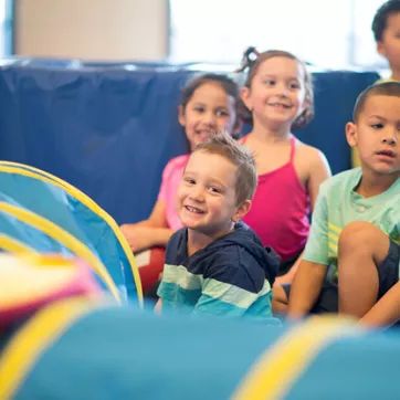 A group of children participate in a tumbling class at the YMCA Gymnastics Center in West Chester