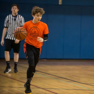 Teen playing basketball at the YMCA of Greater Brandywine