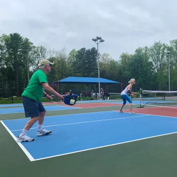 A group of Upper Main Line YMCA members play a game of pickleball on the new outdoor pickleball courts at the Berwyn location. 
