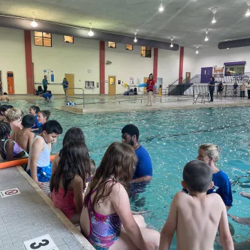 Instructors lead students in water safety programs at the pool 