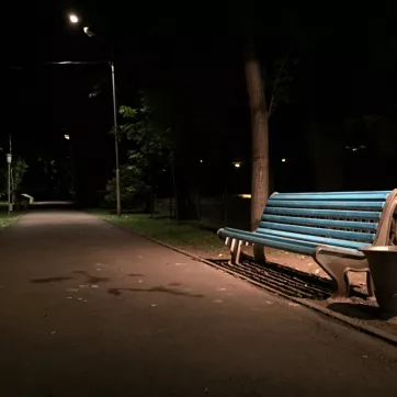 empty park bench at night in a park