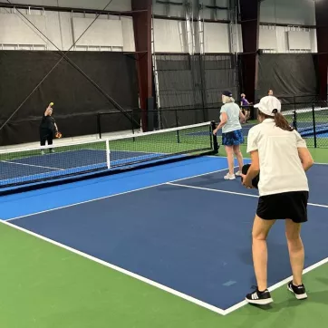two pickleball players await their opponent's serve