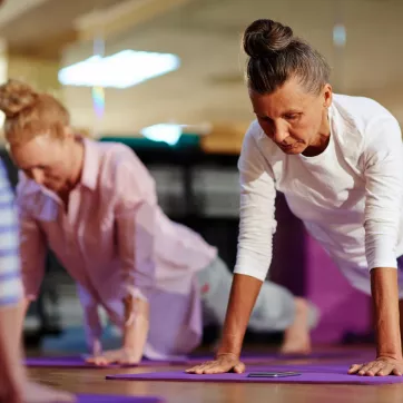 two women doing planks in an exercise class