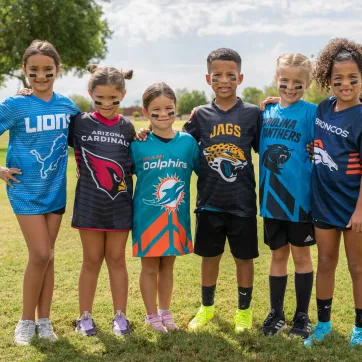 Youth NFL flag football athletes pose for a photo on the outdoor athletic fields at the YMCA