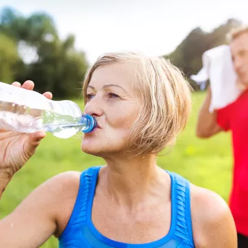 Woman Drinks Water After Exercising