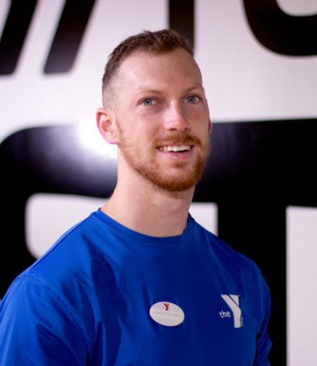 West Chester Area YMCA personal trainer Bryson Long poses for a headshot in the West Chester virtual group exercise studio.