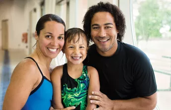 A family poses with their daughter after her swimming lessons at the YMCA indoor swimming pool in Chester County. 